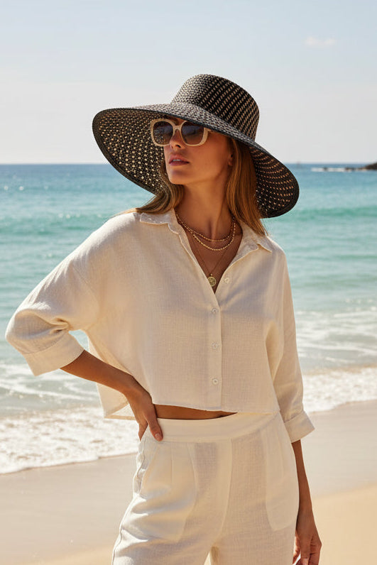 Black woven sun hat on a white background